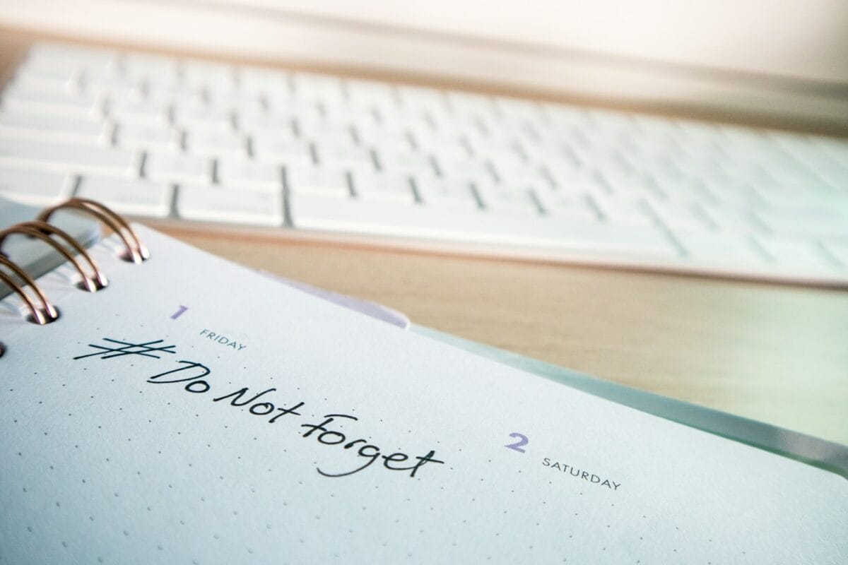 a notepad with a notepad next to a keyboard