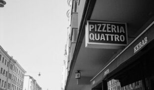 a black and white photo of a street corner