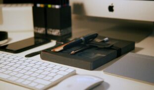 white magic mouse near apple keyboard
