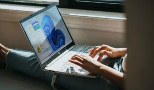 person using Windows 11 computer on lap