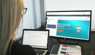 woman sitting in front of turned-on computer monitor