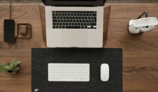 a laptop computer sitting on top of a wooden desk