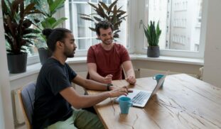 man in black crew neck t-shirt sitting beside woman in red crew neck t-shirt