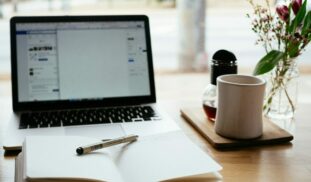 MacBook Pro near white open book