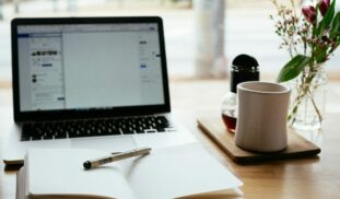 MacBook Pro near white open book