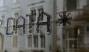 a close up of a window with a building in the background