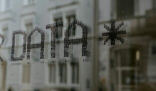 a close up of a window with a building in the background
