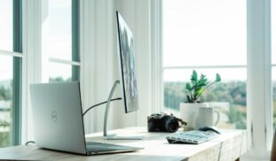 silver laptop on white table
