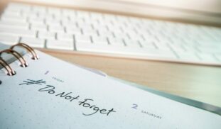 a notepad with a notepad next to a keyboard