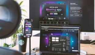 a desk with a laptop and a monitor on it