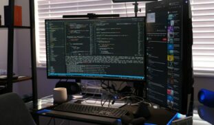 a computer monitor sitting on top of a desk