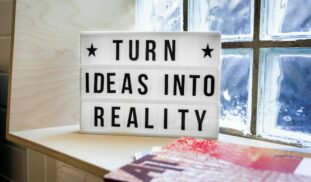 white and black wooden quote board