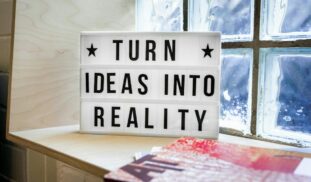 white and black wooden quote board